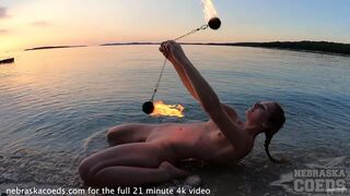 hot model dances with fire at sunset